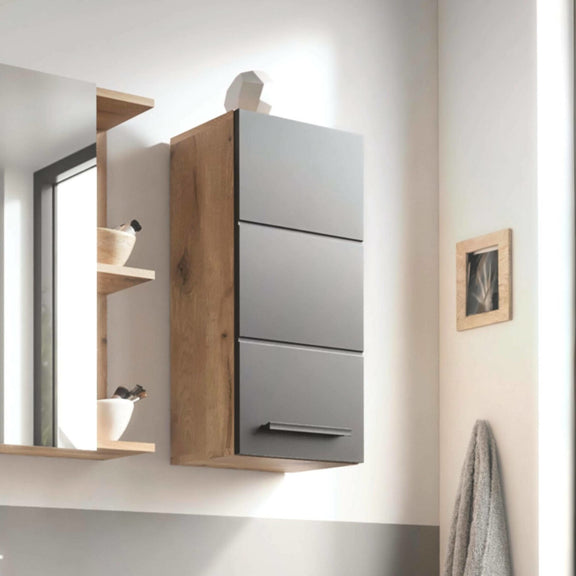 Gray wall-mounted cabinet with wooden accents in a modern bathroom setting.