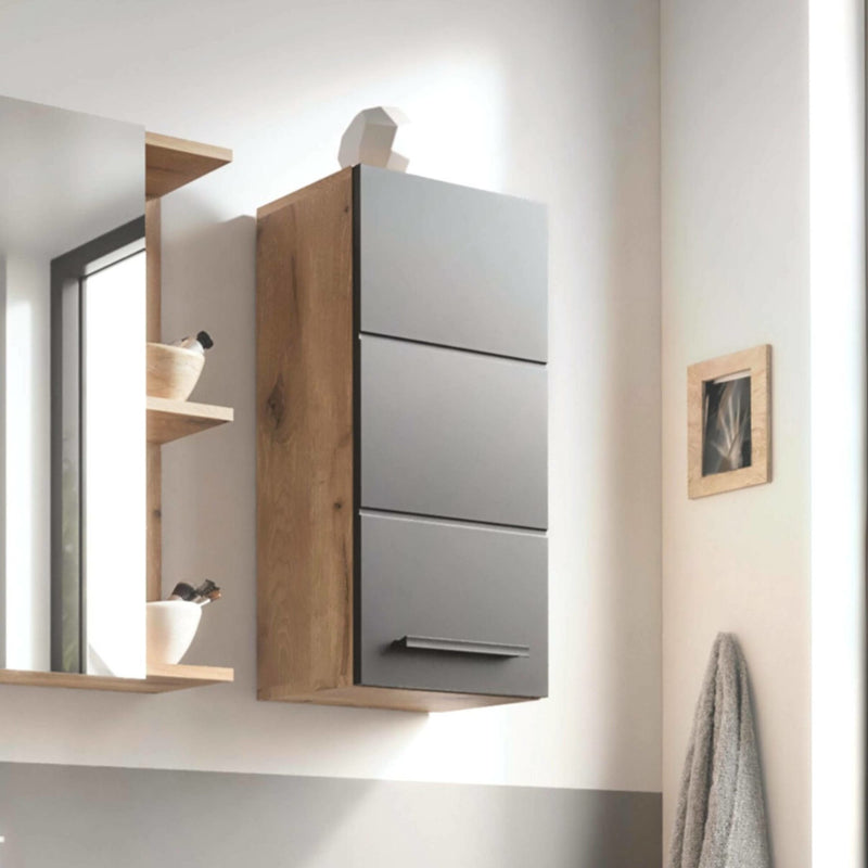 Gray wall-mounted cabinet with wooden accents in a modern bathroom setting.