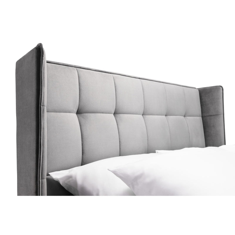 Gray upholstered headboard with tufted design on a white background