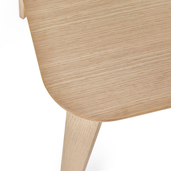 Close-up of a wooden chair with a light finish on a white background