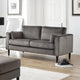 Gray sofa in a living room setting with a rug and decor items.