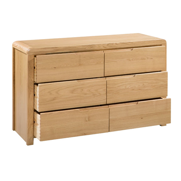 Wooden dresser with multiple drawers on a white background