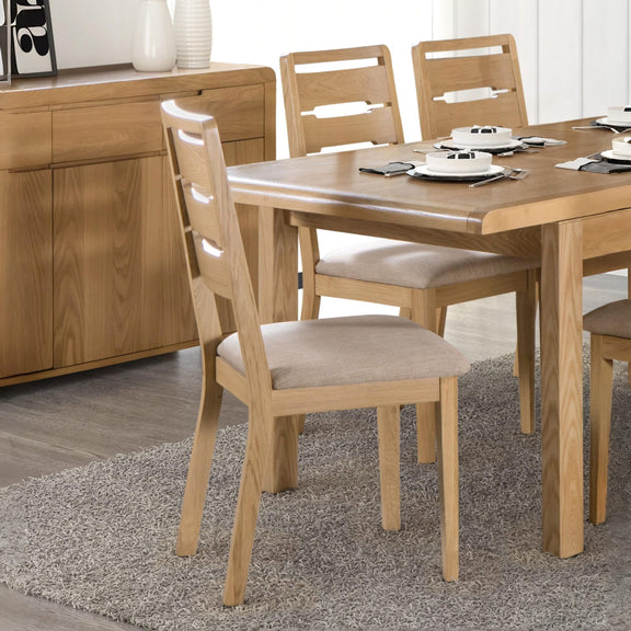 Wooden dining table with chairs in a room setting