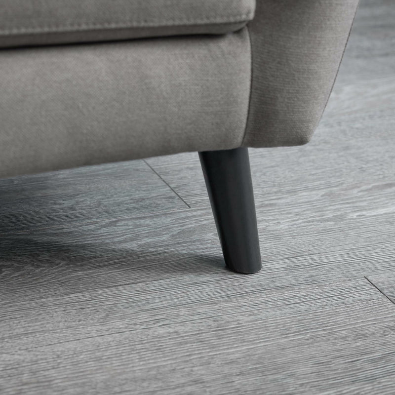 Gray sofa leg on a wooden floor
