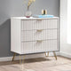 White dresser with gold legs in a room setting