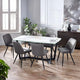 Dining room with a marble table and gray chairs in a modern setting.