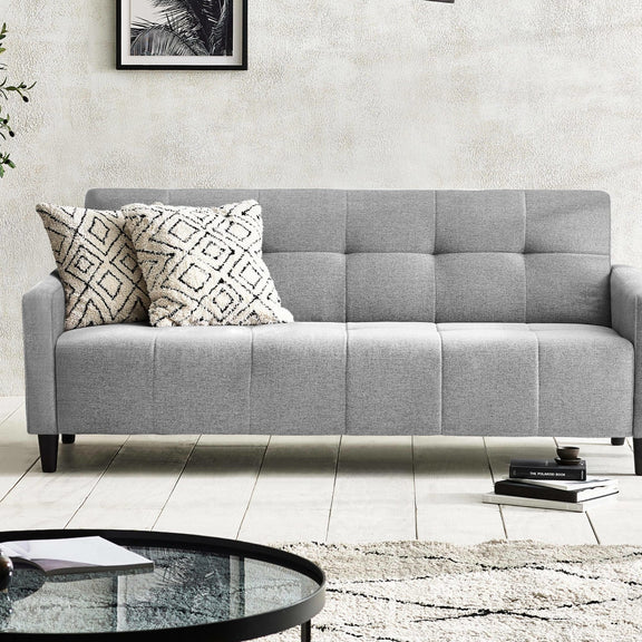 Gray sofa with patterned cushions in a living room setting