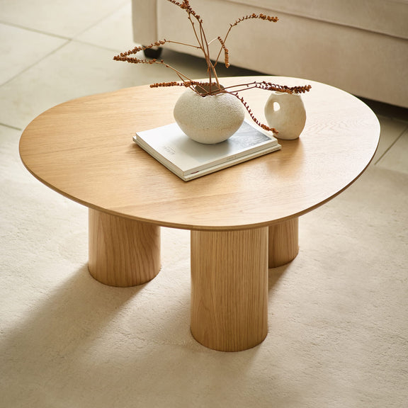 Wooden coffee table with decorative items on a light-colored floor