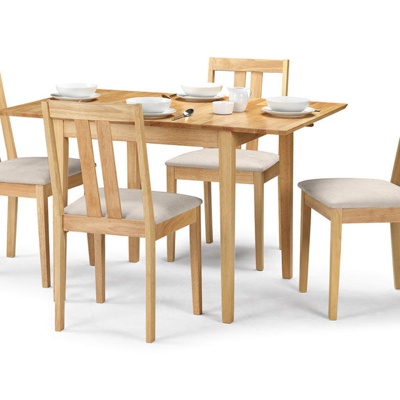 Wooden dining table with four chairs on a white background