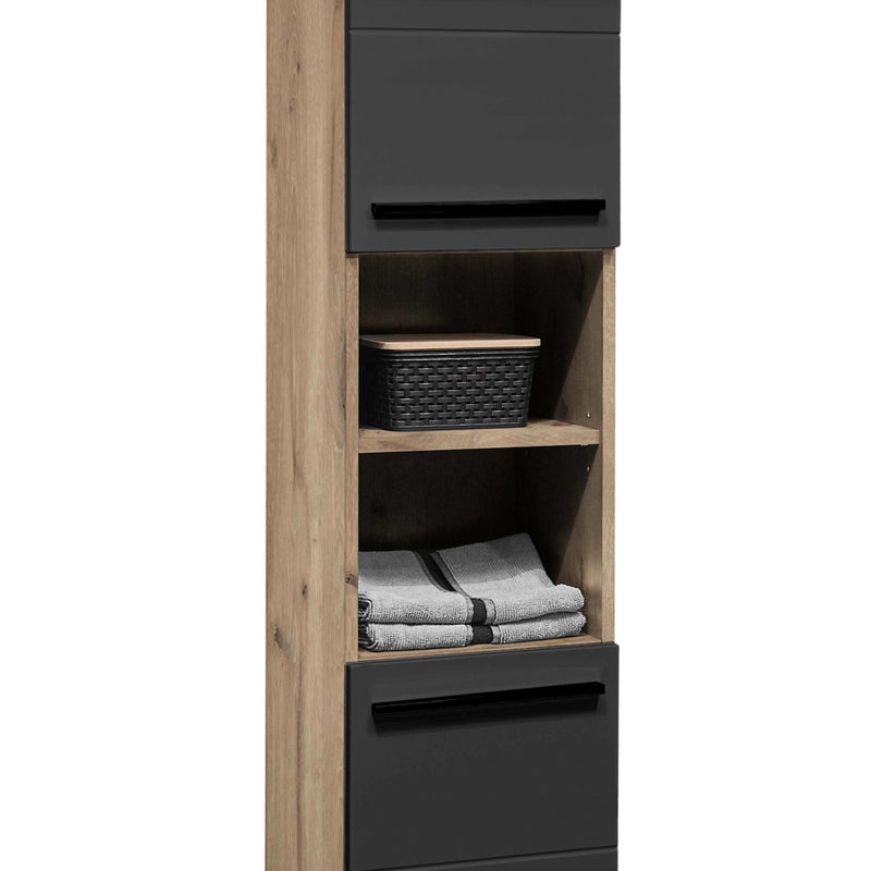 Tall bathroom cabinet with wooden finish and black drawers, containing towels and a basket.