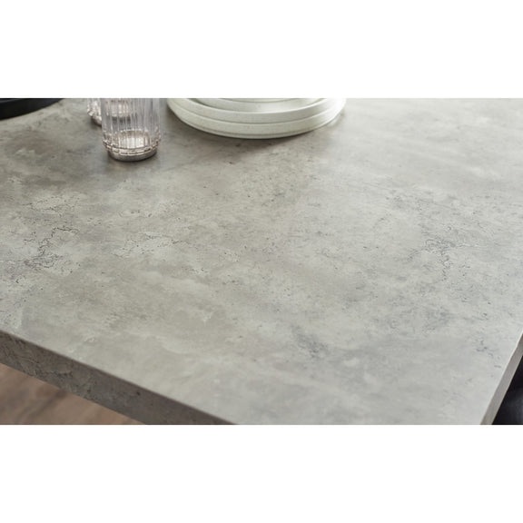 Gray concrete-style countertop with a glass and plates on a white background