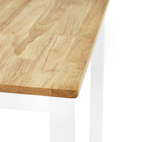 Close-up of a wooden table corner with a white base