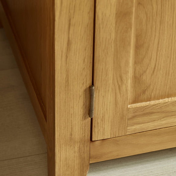 Close-up of a wooden cabinet with a hinge