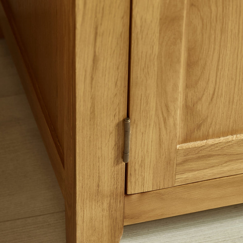 Close-up of a wooden cabinet with a hinge