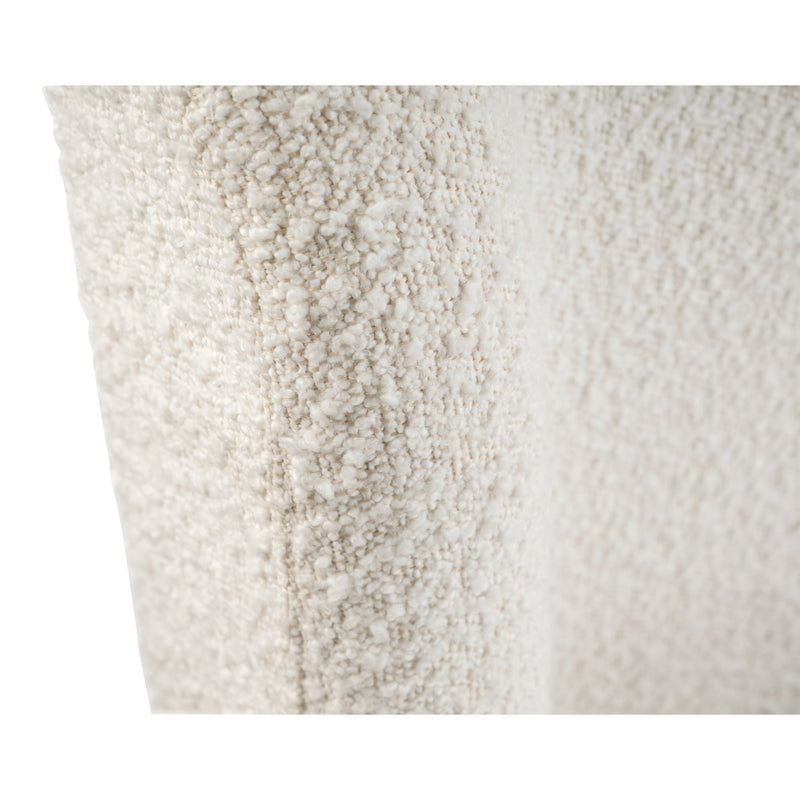 Close-up of a textured white pillow with a subtle pattern.