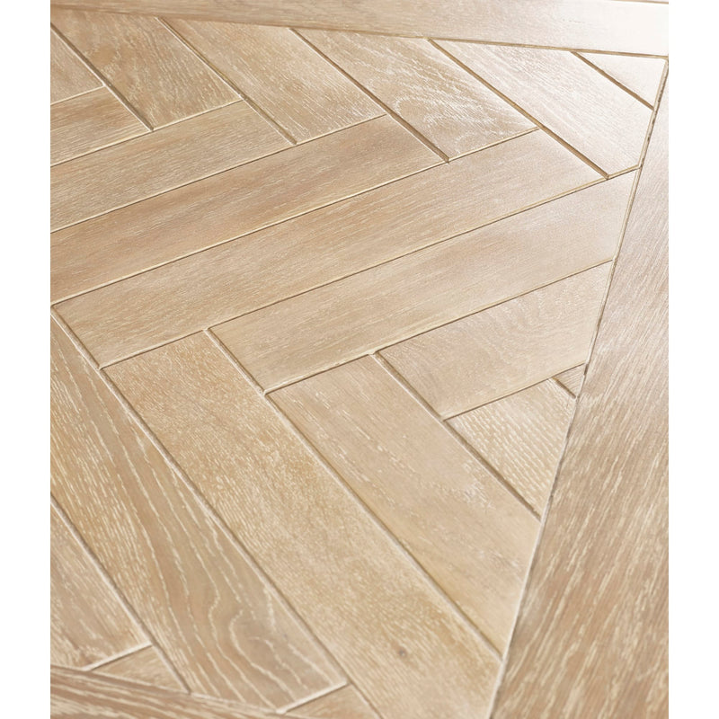 Beige tiles arranged in a herringbone pattern on a white background