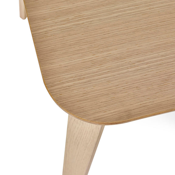 Close-up of a wooden chair with a light brown finish on a white background