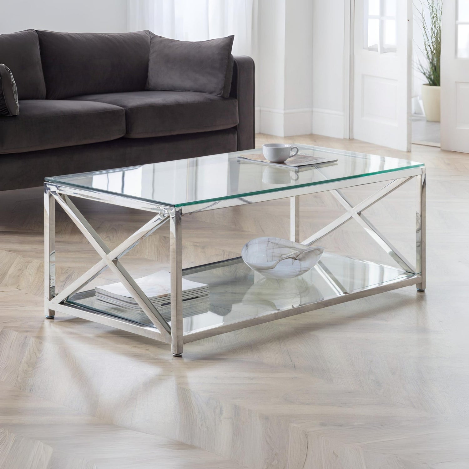 Glass coffee table with metal frame in a living room setting