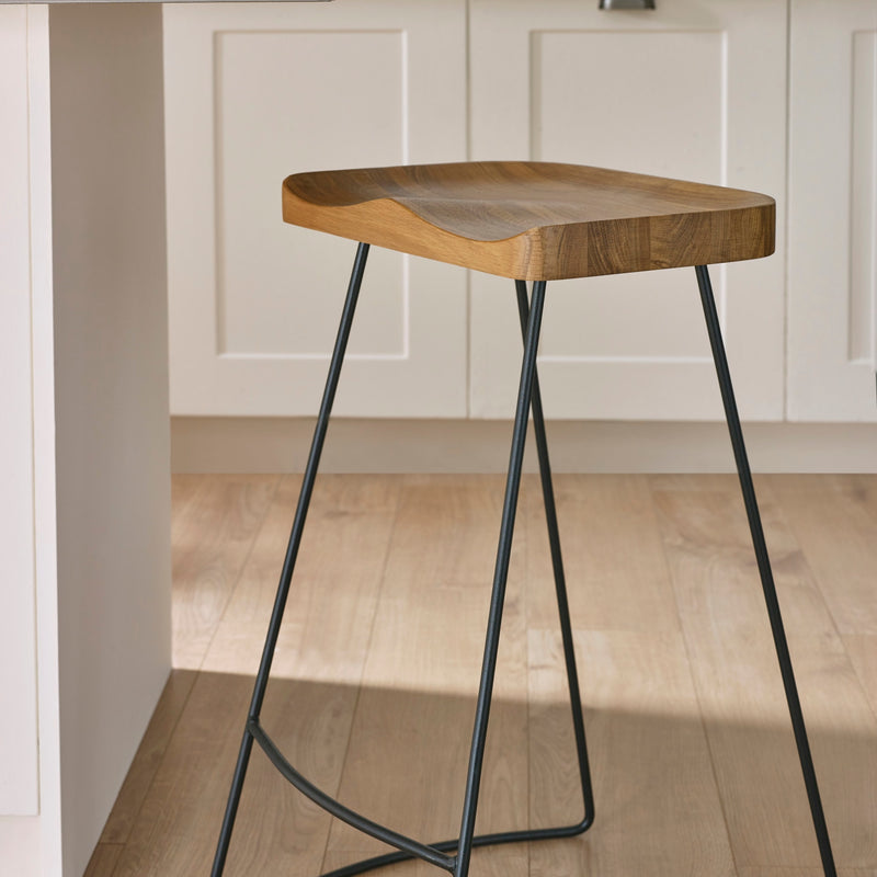 Wooden bar stool with metal legs in a kitchen setting
