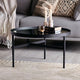 Black coffee table with decorative items in a living room setting