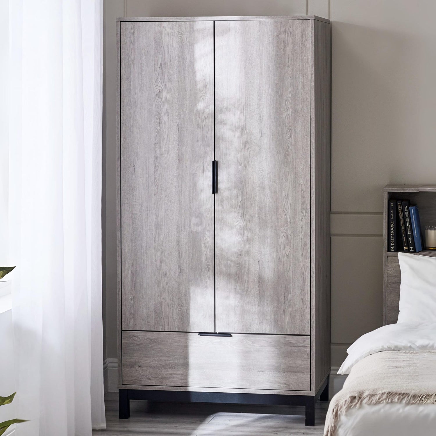 Wooden wardrobe with two doors in a bedroom setting