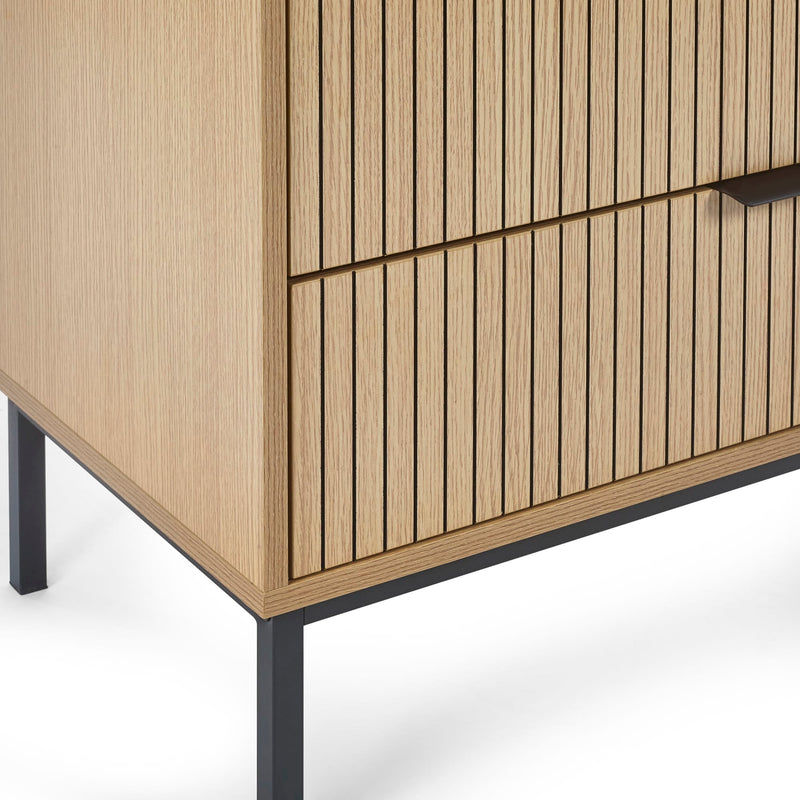 Wooden cabinet with vertical slats and black metal legs on a white background