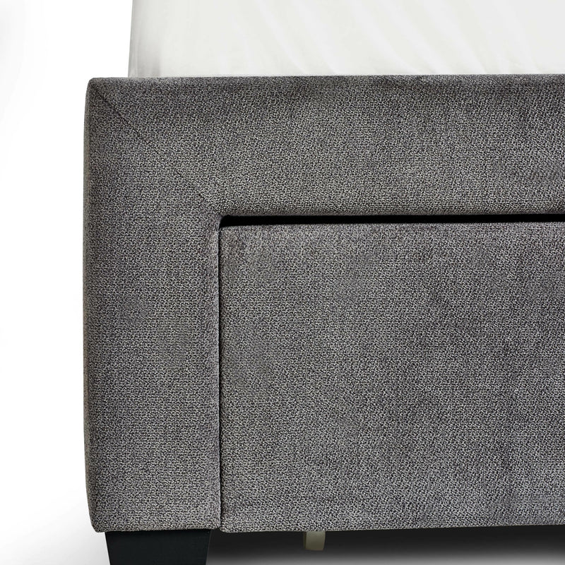 Gray upholstered corner of a piece of furniture on a white background