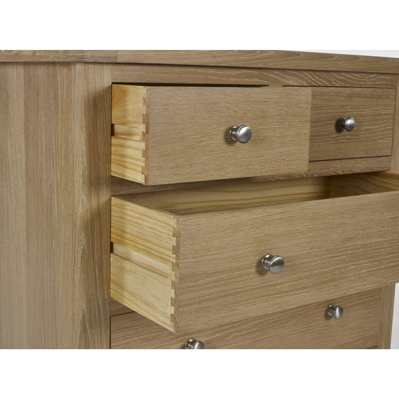 Wooden dresser with three drawers and metal handles on a white background