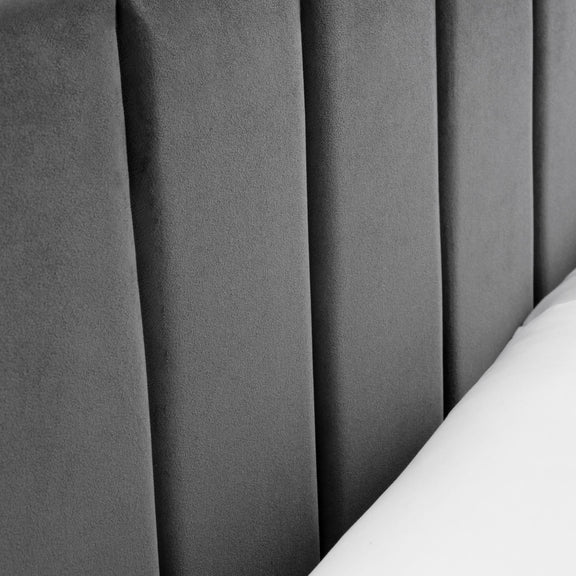 Close-up of gray pleated fabric with a white edge