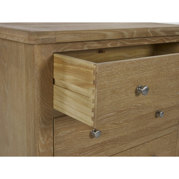 Wooden drawer with metal handles on a wooden cabinet.
