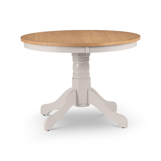 Round wooden table with white base on a white background
