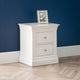White nightstand with two drawers against a blue wall