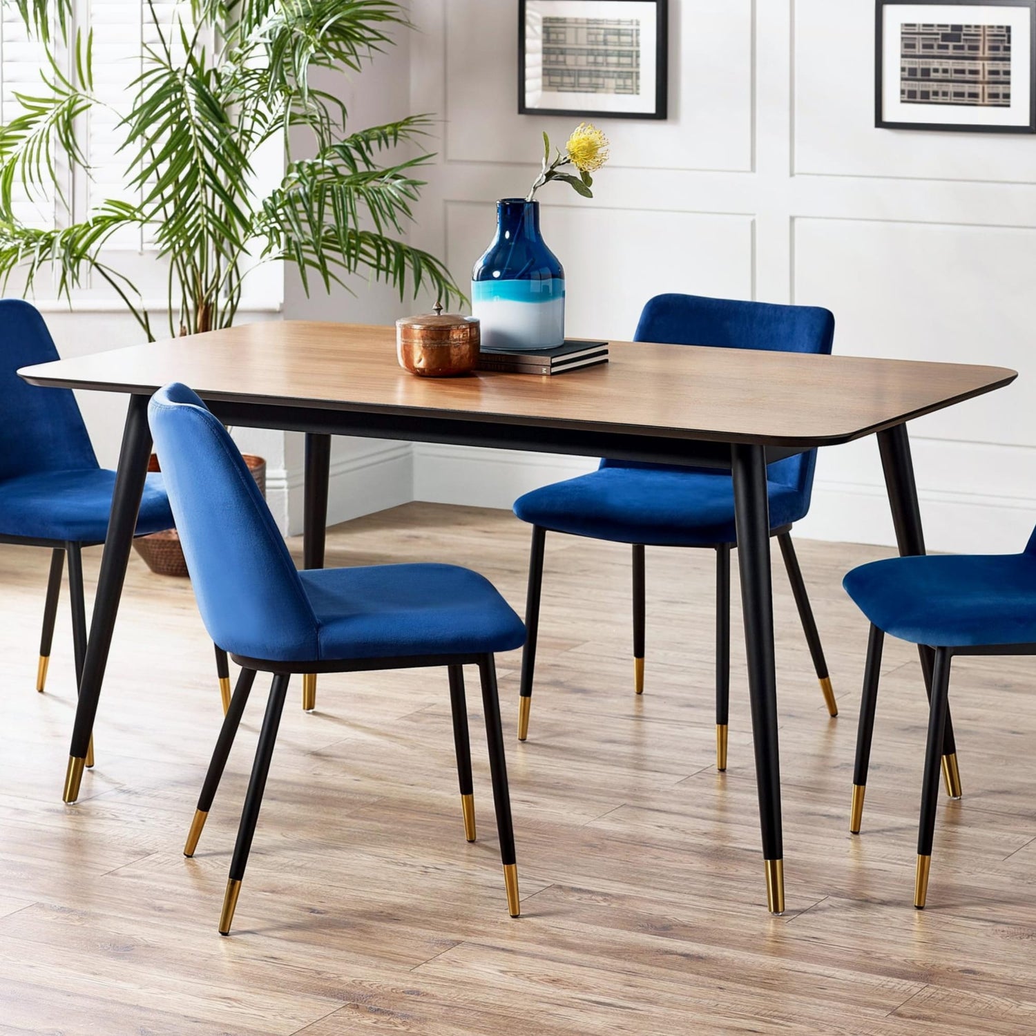 Dining room with a wooden table and blue chairs on a wooden floor.
