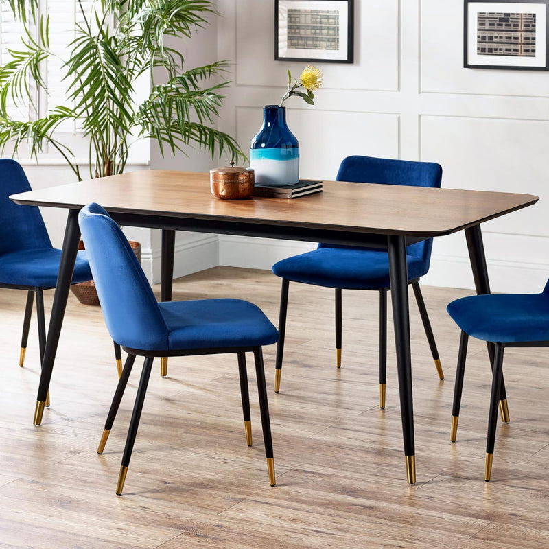 Dining room with a wooden table and blue chairs on a wooden floor.