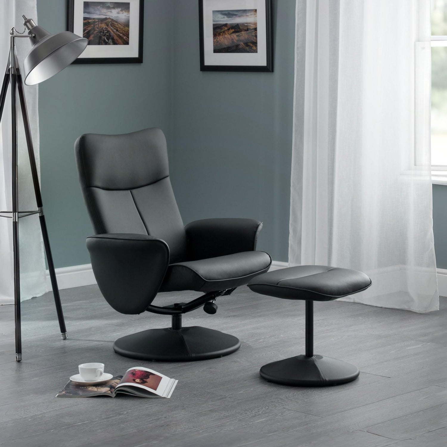 Black leather recliner chair with ottoman in a room with a lamp and window.