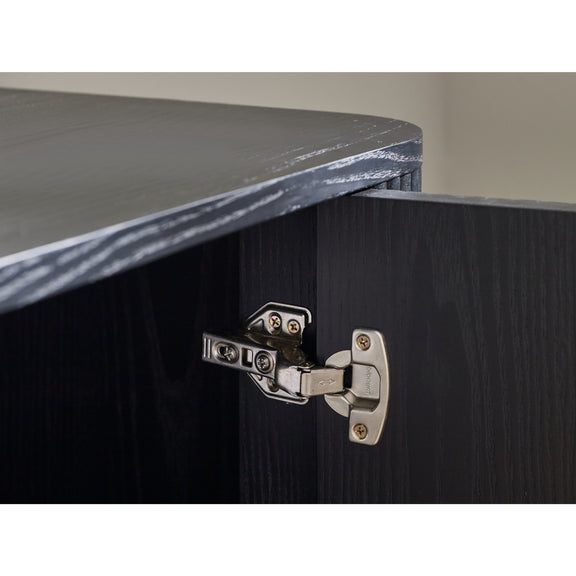 Close-up of a cabinet hinge on a wooden surface