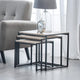 Set of three nesting tables with a clock and lamp in a living room setting.
