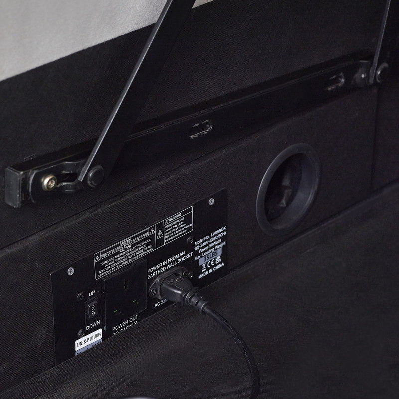 Back panel of a black electronic device with control buttons and a USB cable plugged in.