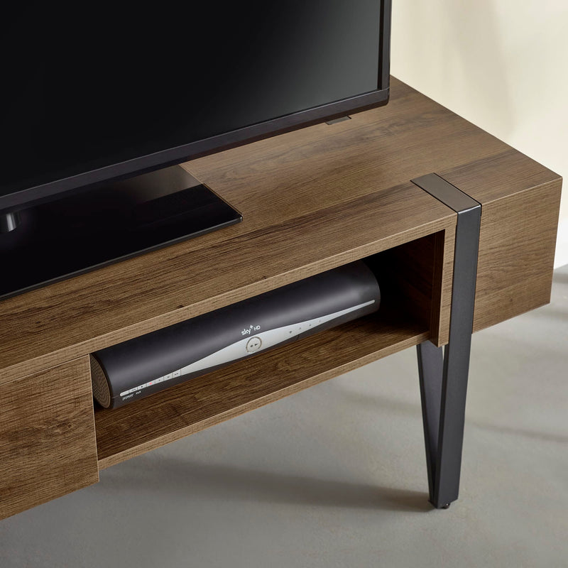 Wooden TV stand with a television and soundbar on a neutral background