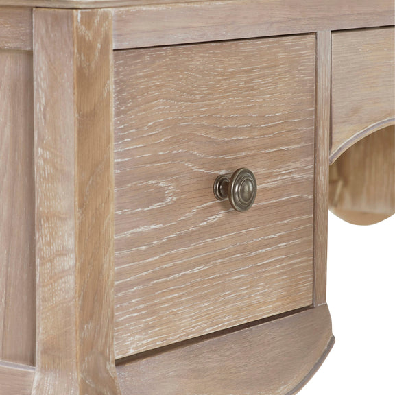 Close-up of a wooden drawer with a knob on a piece of furniture.