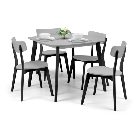 Dining table set with four chairs on a white background