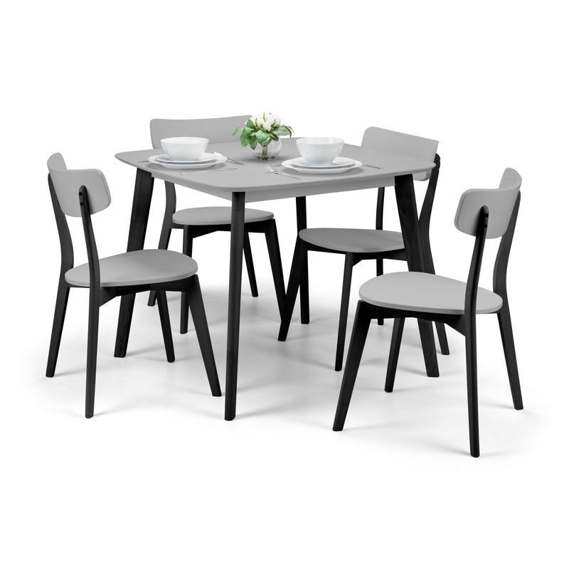 Dining table set with four chairs on a white background