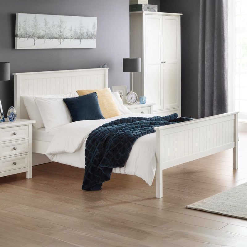 Neatly arranged bedroom with a white bed, nightstands, and decor.