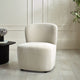 Beige armchair in a room with a light wooden floor and white walls.