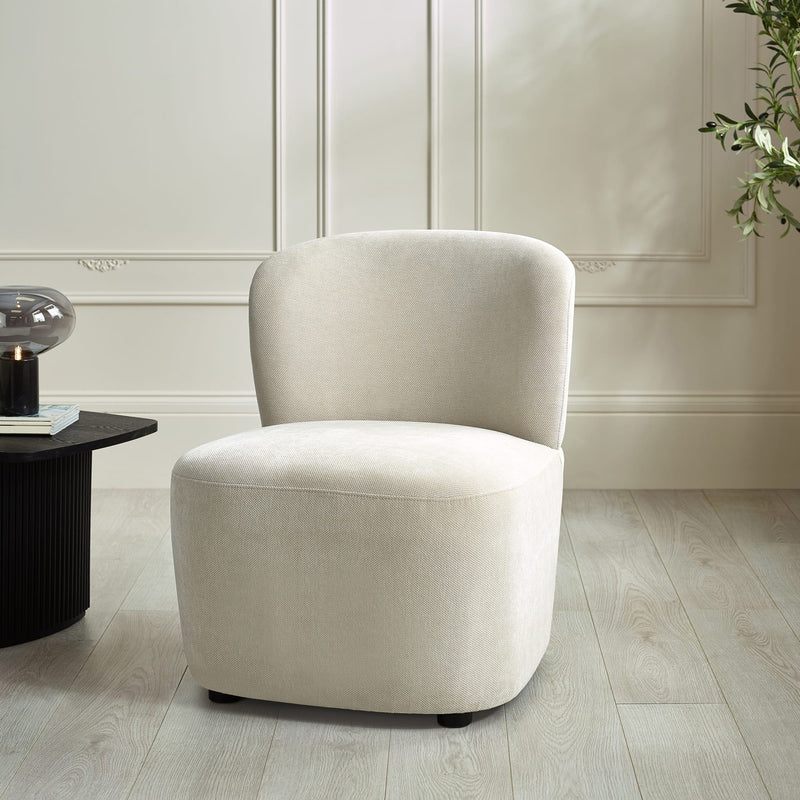 Beige armchair in a room with a light wooden floor and white walls.