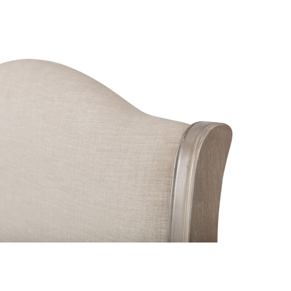 Close-up of a beige upholstered headboard with wooden trim on a white background