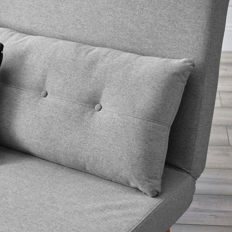 Gray upholstered chair with a cushion on a wooden floor