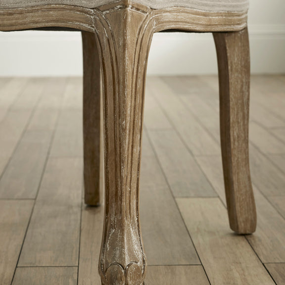 Close-up of a wooden chair leg on a wooden floor