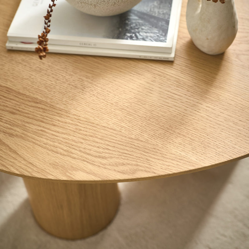 Wooden table with a vase and decorative items on a light background