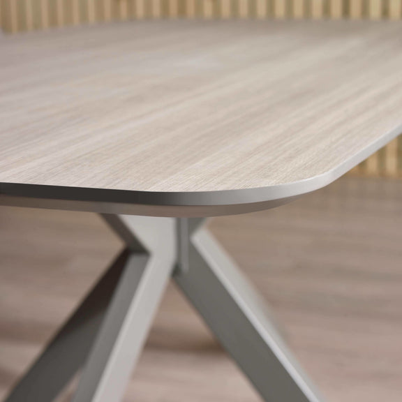 Round wooden table with a metal base on a blurred background